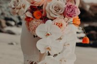 a cascading wedding bouquet of white orchids, pink, peachy, pale pink roses and orange touches is adorable