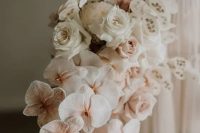 a cascading wedding bouquet of white roses, blush orchids, lunaria and grasses is a luxurious idea for a modern wedding with a twist