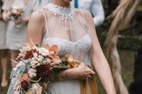 a cascading wedding bouquet with rust, burgundy and blush blooms and greenery plus mustard ribbons is a chic and bold idea for a fall bride