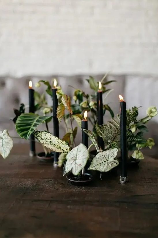 a creative botanical wedding centerpiece with leaves and black candles is a cool idea for Halloween