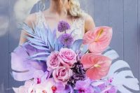 a jaw-dropping iridescent wedding bouquet with colorful fronds, blooms and leaves, in purple, pink and blue is amazing