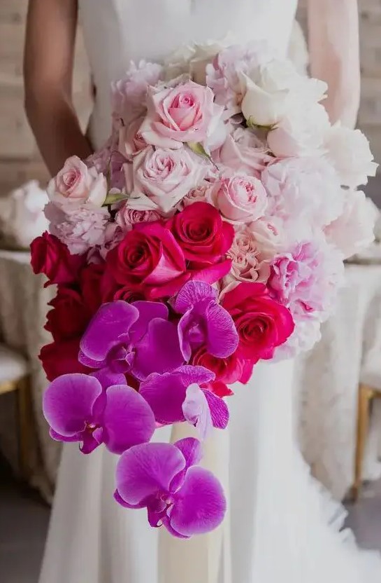 a jaw-dropping wedding bouquet from white to light pink, fuchsia and bold purple and a cascading effect is a bright idea