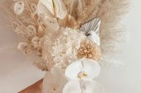 a lovely neutral boho wedding bouquet of hydrangeas, lunaria, orchids, fronds, pampas grass and anthurium is a gorgeous idea