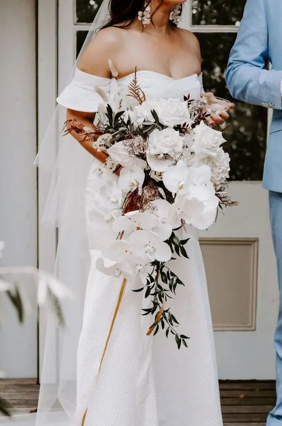 a luxurious modern cascading wedding bouquet with white roses, orchids, greenery and bunny tails is a lovely idea to go for