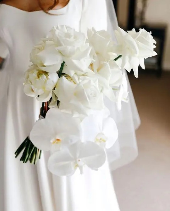 a sophisticated white rose and orchid wedding bouquet is a gorgeous idea for a modern or minimalist bride