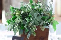a wooden box with herbs, greenery and succulents for a relaxed woodland wedding