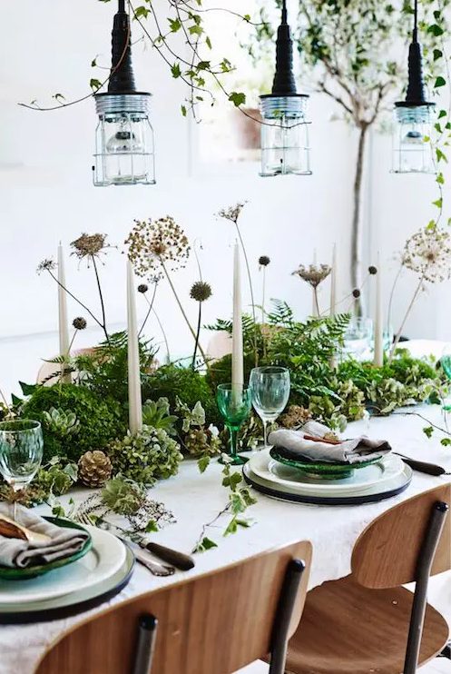 a woodland style wedding centerpiece of greenery, succulents, dired blooms and pinecones for a Nordic woodland summer or fall wedding