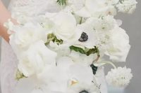 an all-white wedding bouquet of orchids, roses, anemones and some dahlias is a cool and fresh idea