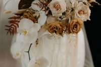 an earthy wedding bouquet of orchids, coffee-colored roses and blush ones, anthurium, grasses and leaves