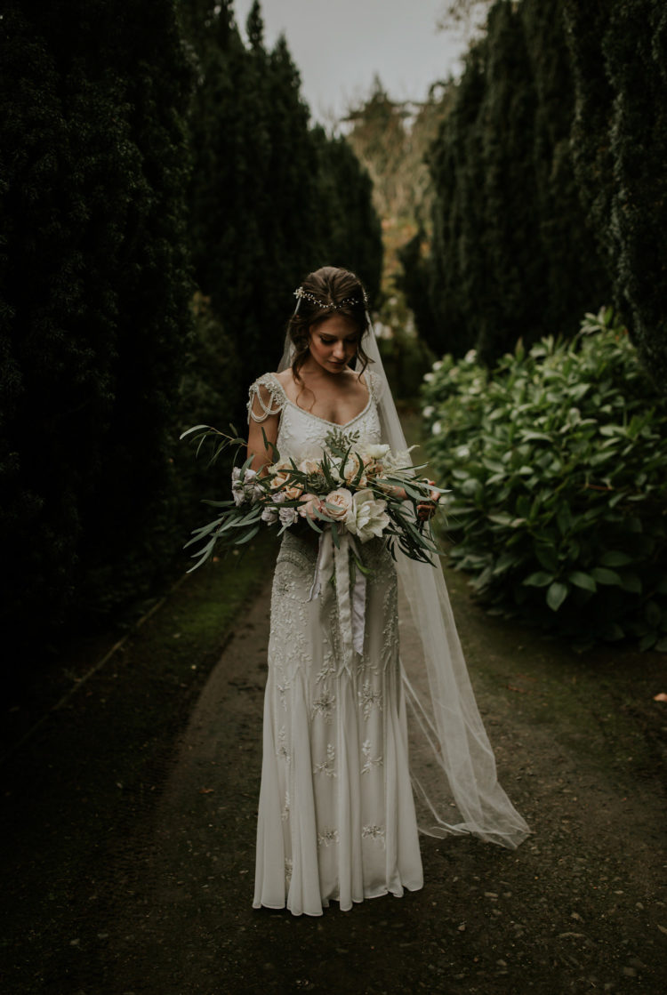 The bride was wearing a beautiful embellished dress with draped cap sleeves in 1920s style