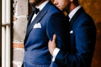02 The grooms were wearing navy tuxedos with black lapels and chose different ties