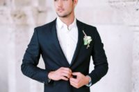 02 a black groom’s suit with a white shirt and a boutonniere is a timeless and effortlessly chic look