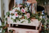 02 a cute rustic wedding decoration with crates, greenery, blooms and candle lanterns