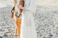 03 The bride was wearing a gypsy-style wedding gown with a lace bodice and long sleeves, a high neckline and a flowy skirt