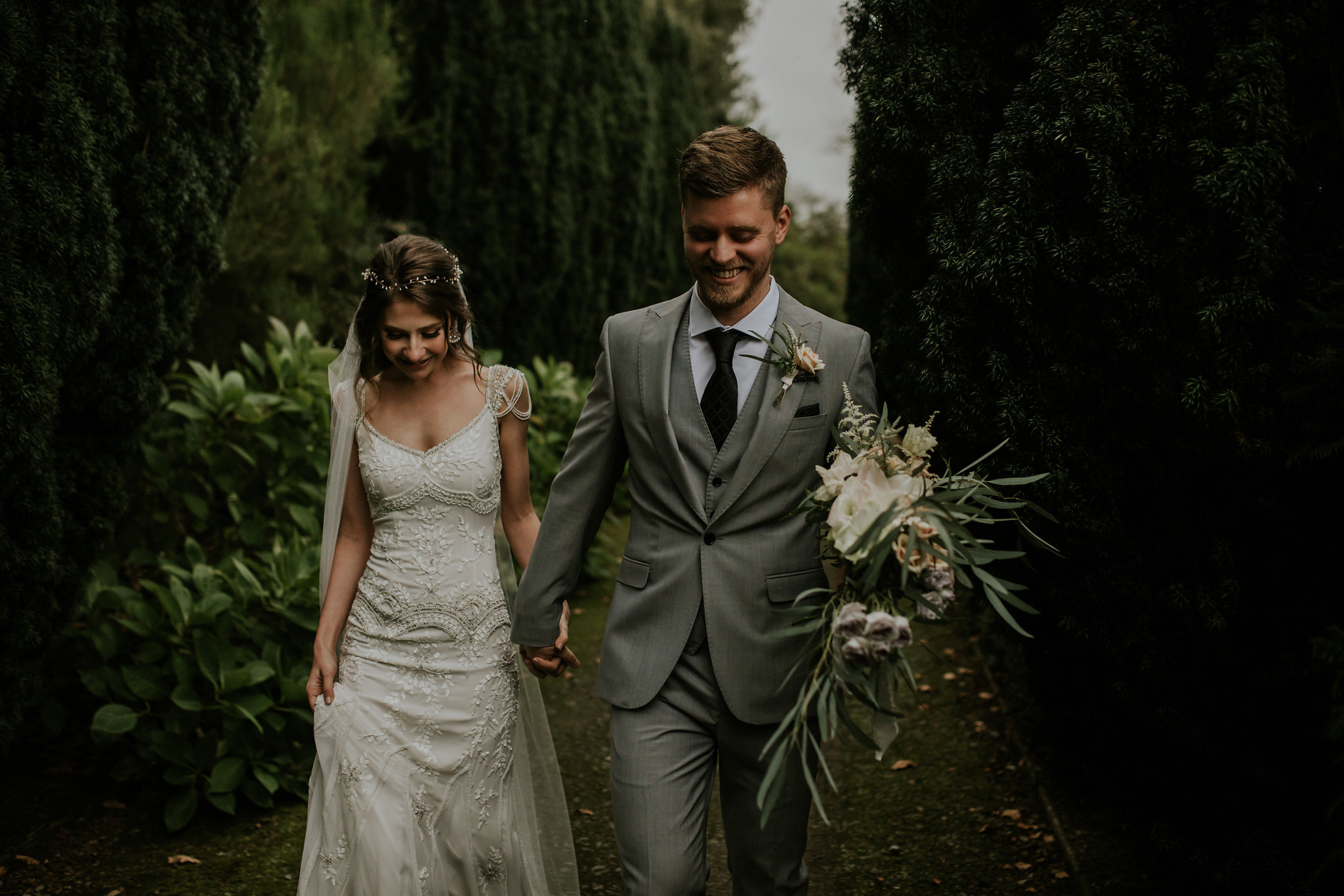 The groom was wearing a three piece grey suit with a dark printed tie