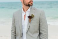 03 a grey suit, a white shirt, an amber belt for a relaxed yet stylish beach look