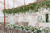 03 a hanging ladder over the reception decorated with lush greenery and pendant lights for a refreshing look