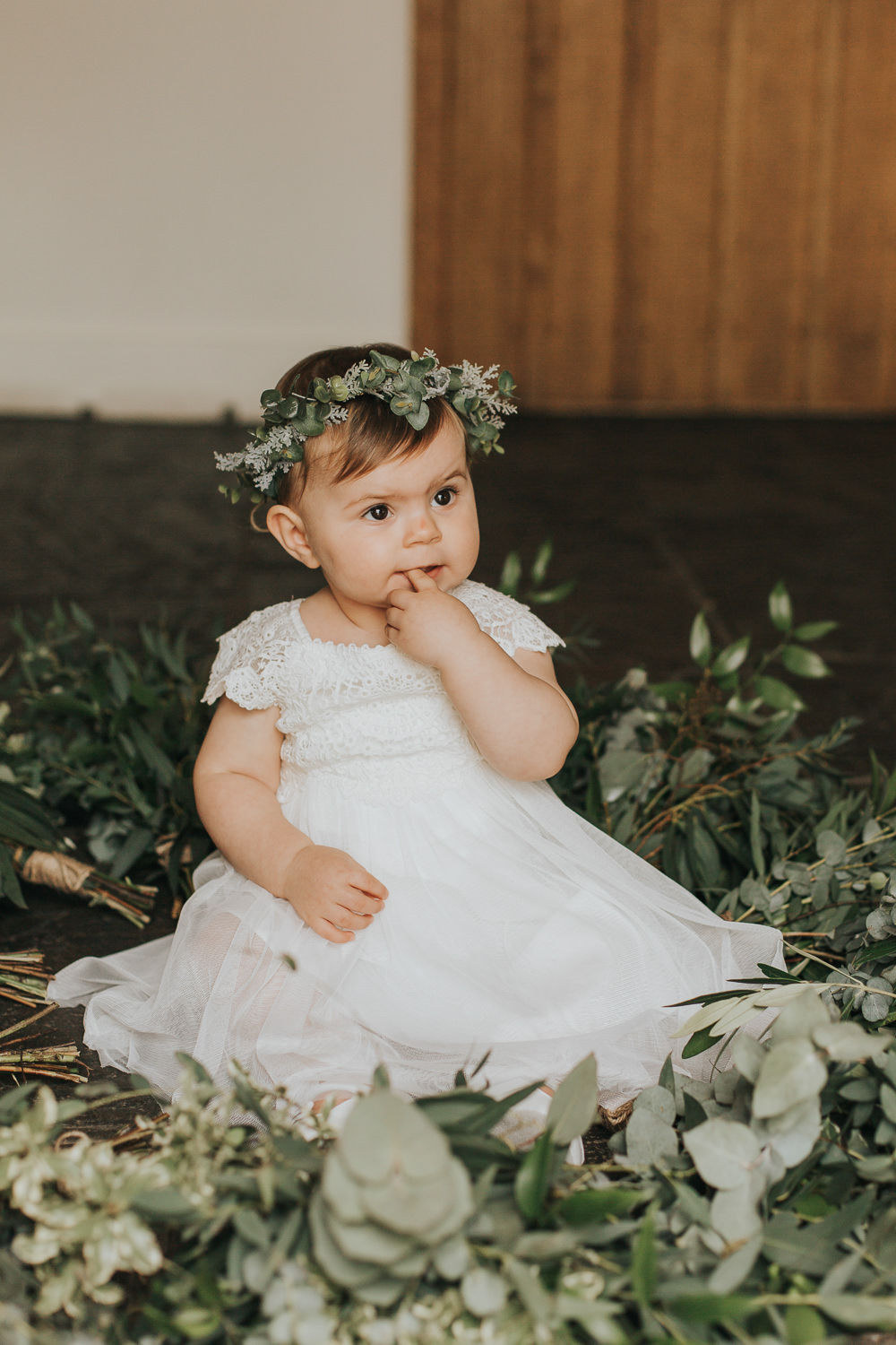 The daughter of the couple was dressed in a cute lace gown and a greenery crown