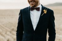 04 The groom was wearing a navy tuxedo with a polka dot bow tie and a billy ball boutonniere