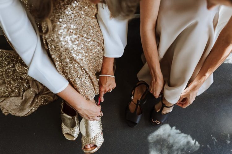 One girl chose black heels and the second chose gold mules