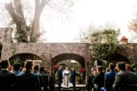 05 The ceremony space was an antique stone arch and there were two bright floral topiaries on each side