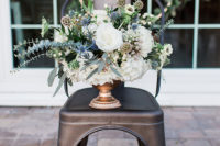07 The wedding florals were done with much textural greenery, white blooms and blue thistles