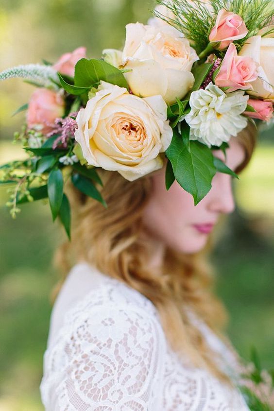 an oversized floral crown with roses and much greenery for a midsummer boho bride