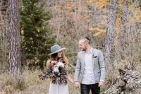07 black jeans, a white shirt, a grey blazer and a trendy hairstyle for a woodland elopement