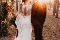 08 Ruby Margaux lace wedding gown with a cutout back, long sleeves, a train and a deep V-neckline