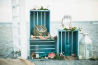 08 a bright crate combo in turquoise with candle lanterns and bottles, shells and star fish for a beach wedding
