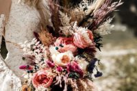 08 a luxurious boho wedding bouquet with pampas grass, feathers, peonies and berries for a wow effect