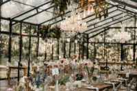 10 The wedding venue was done with chic greenery chandeliers, clear chairs, mismatching vases with flowers