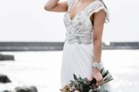 10 a boho glam wedding gown with an embellished bodice, a V-neckline and cap sleeves plus a matching bracelet