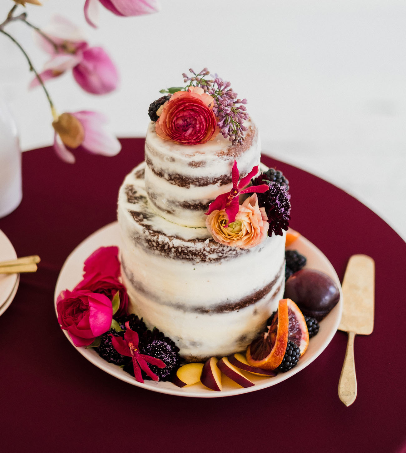 The wedding cake was a naked one, with fresh blooms and fruits that were bold touches