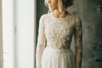 11 a chic fitting dress with a lace embellished bodice with long sleeves and a high neckline and a plain skirt