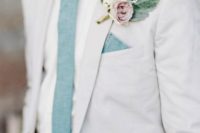 11 a white suit, a white shirt, a mint green tie and a mauve boutonniere for a summer garden wedding