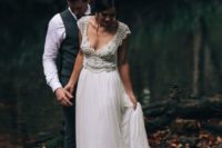 a chic vintage-inspired wedding dress with an embellished bodice, a V-neckline and a layered skirt