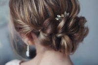 12 an elegant updo with a large braided element, a bump and a rhinestone hairpiece for a romantic feel