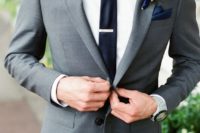 14 a graphite grey suit, an ivory shirt, a navy tie and handkerchief for a modern outfit