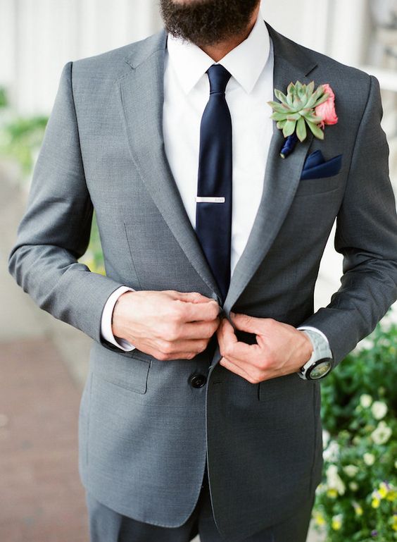 a graphite grey suit, an ivory shirt, a navy tie and handkerchief for a modern outfit