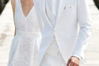 15 a gorgeous white three-piece suit with a patterned vest, a white shirt, a white bow tie and a white boutonniere