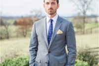 15 a grey suit is spruced up with a bold blue printed tie for a brighter look and a more modern feel