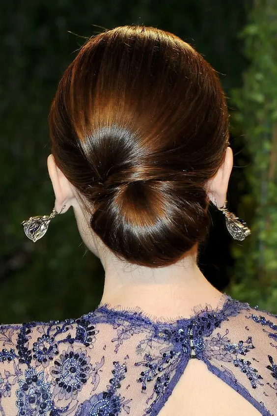 a elegant low chignon with a sideswept section is a very durable option for a picture perfect look