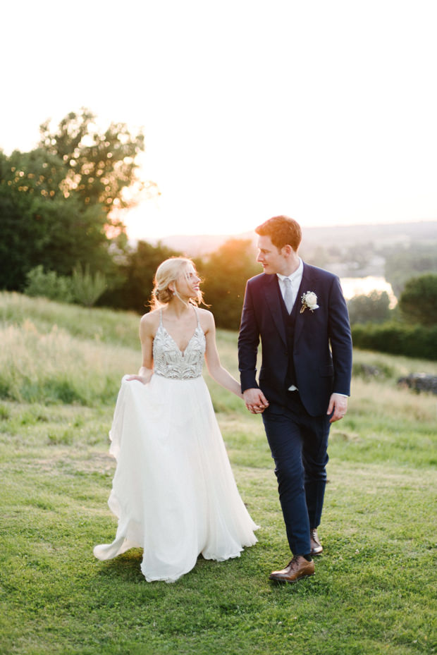 a gorgeous wedding dress with spaghetti straps and a heavily embellished bodice plus a flowy skirt