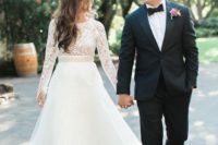 17 a modern A-line wedding dress with a lace bodice with long sleeves and a layered tulle skirt
