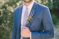 18 a blue suit with a light blue tie and a herby boutonniere for a romantic and chic look