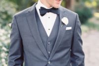 18 a classic graphite grey three-piece wedding suit with a black bow tie and a shirt with black buttons
