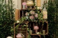 18 a sweets table alternative built of crates, decorated with blooms and greenery and with candy jars inside