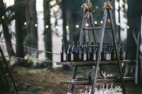 19 a woodland wedding bar made of a ladder and shelves and decorated with moss and antlers