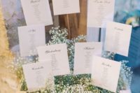 19 display your seating chart in a crate filled with baby’s breath and with a seating plan
